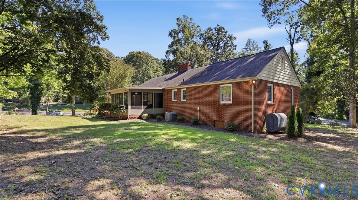 Brick exterior with a screened porch, white window trim, and a gabled roof