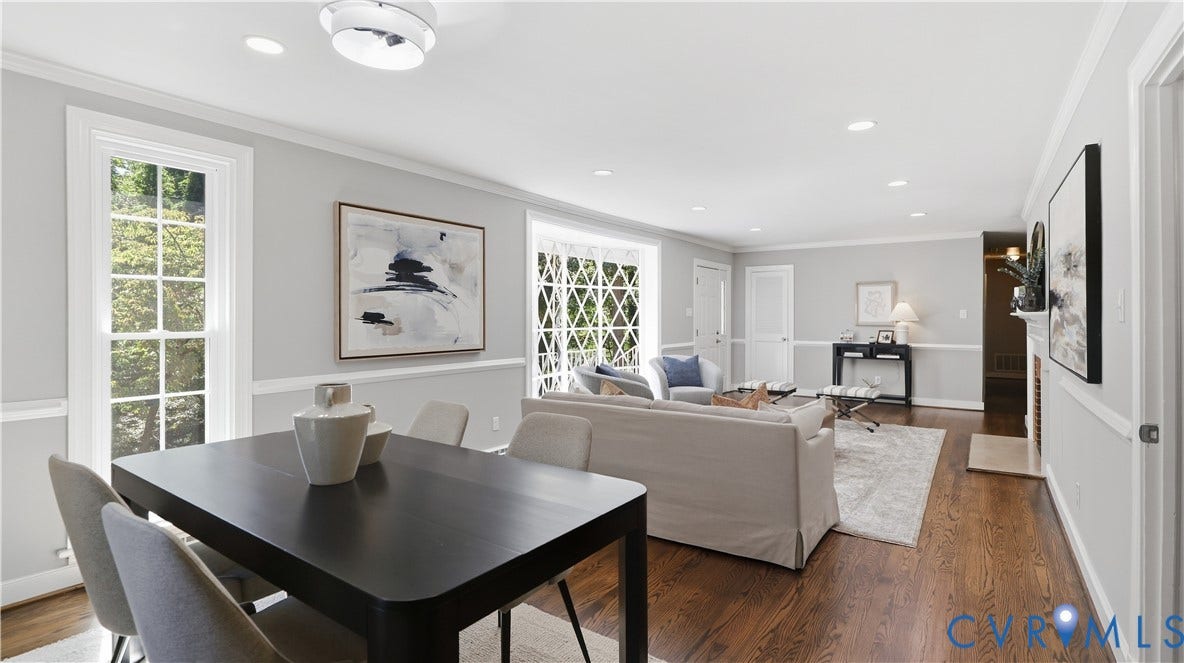 Hardwood flooring, crown molding, chair rail molding, recessed lighting, and a fireplace with a mantel
