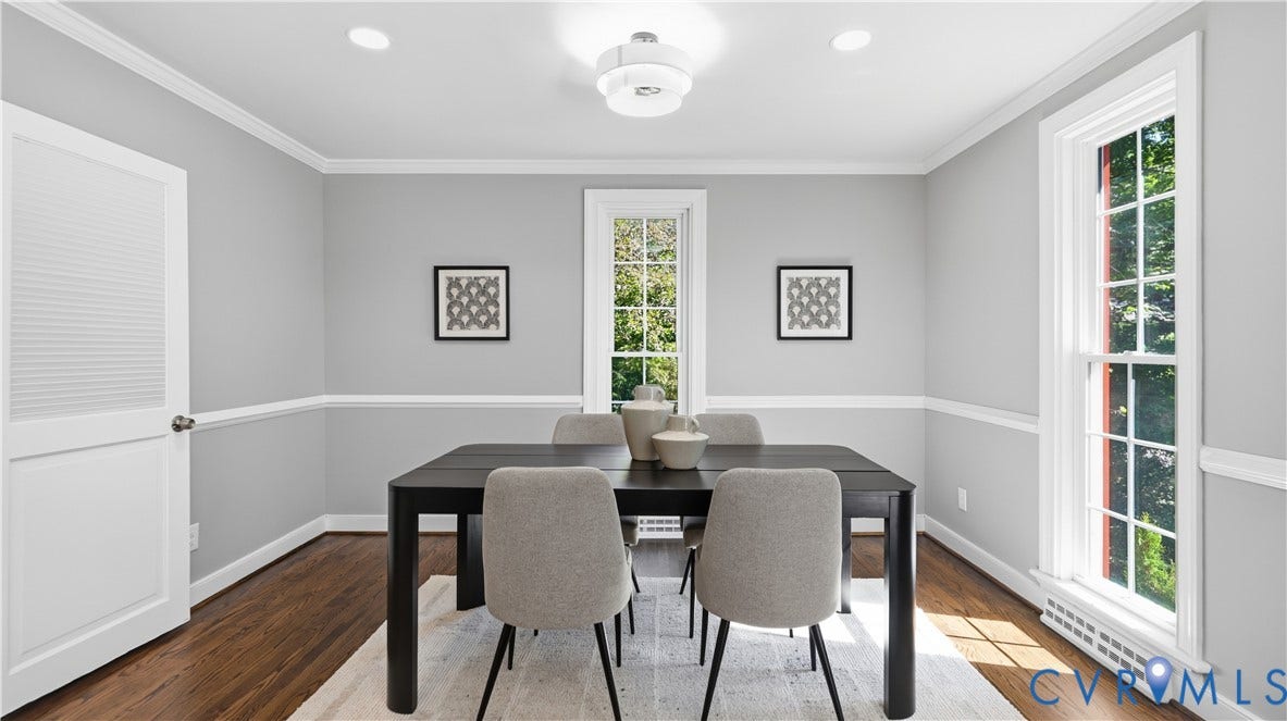 Hardwood flooring, crown molding, chair rail detailing, recessed lighting, and a modern flush mount light fixture