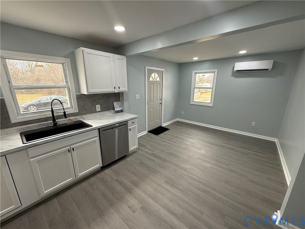 129 S Old Church Street, Petersburg, VA 23803 Kitchen with tasteful backsplash, an AC wall unit, a sink, dishwasher, and baseboards