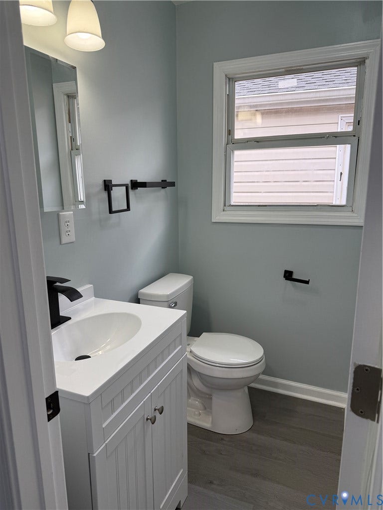 129 S Old Church Street, Petersburg, VA 23803 Bathroom with baseboards, vanity, toilet, and wood finished floors