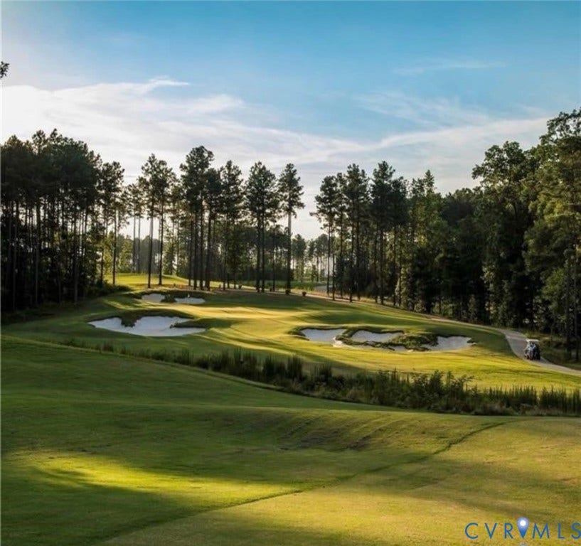 7319 Vicenzo Drive, Moseley, VA 23120 Expansive golf course featuring multiple sand traps, mature pine trees, and a paved cart path