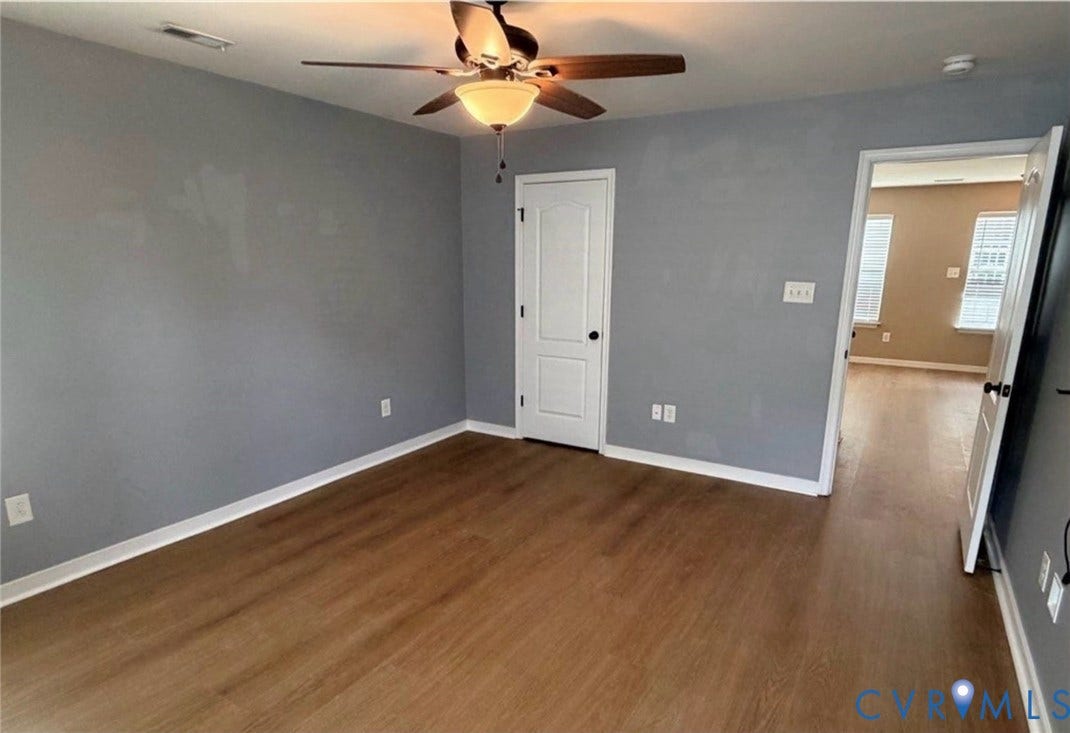 7319 Vicenzo Drive, Moseley, VA 23120 Wood-finish flooring with light gray walls, white trim, and a ceiling fan with light fixture