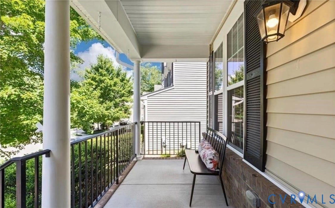 7319 Vicenzo Drive, Moseley, VA 23120 Covered front porch featuring white columns, black metal railings, and a concrete surface