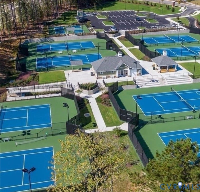 7319 Vicenzo Drive, Moseley, VA 23120 Multiple hard-surface tennis courts with perimeter fencing, a central clubhouse structure, a covered viewing pavilion, and paved parking
