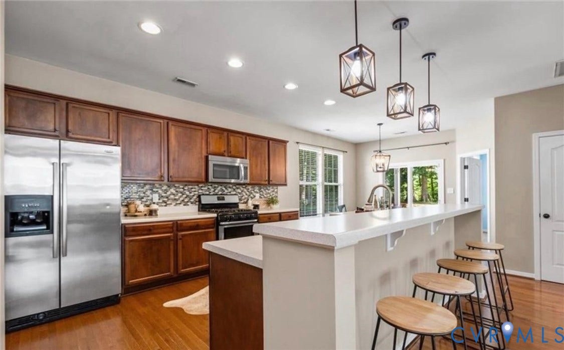 7319 Vicenzo Drive, Moseley, VA 23120 Kitchen featuring wood-finish flooring, stainless steel appliances, dark wood cabinetry, a tiled backsplash, and recessed lighting