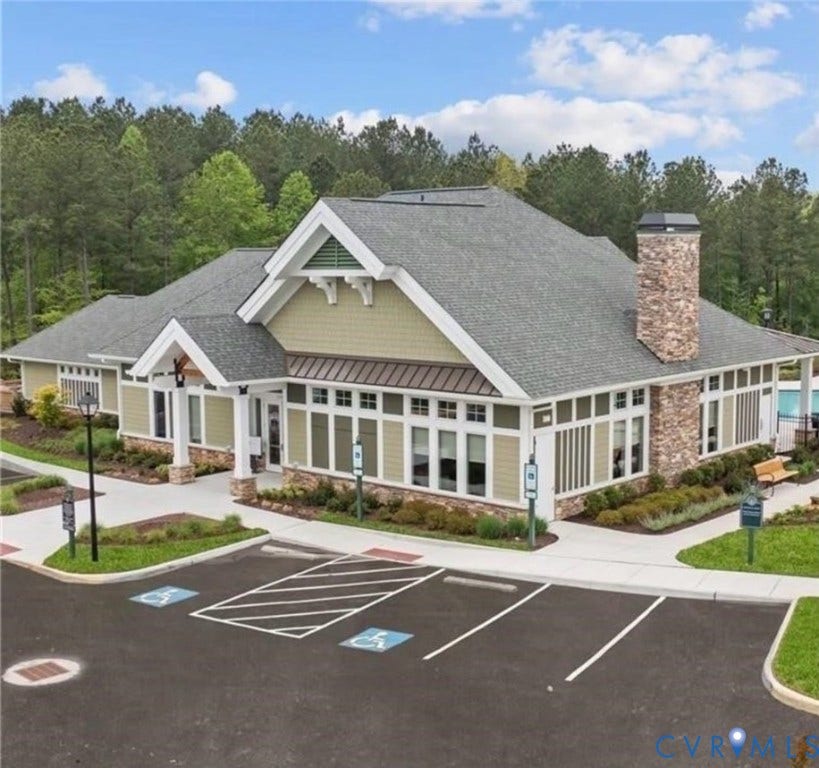 7319 Vicenzo Drive, Moseley, VA 23120 Stone and siding exterior with a prominent stone chimney, multi-pane windows, and covered entry