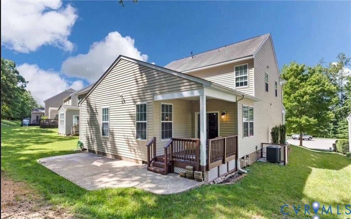 7319 Vicenzo Drive, Moseley, VA 23120 Covered back deck with wood railing, attached patio, and expansive green space