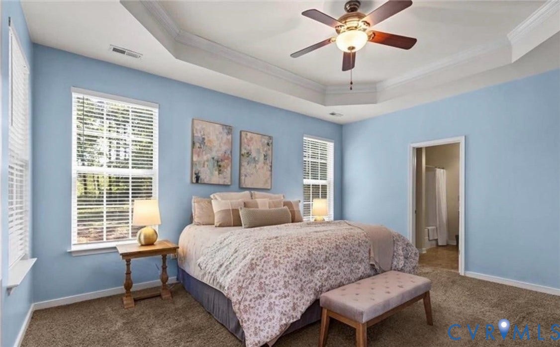 7319 Vicenzo Drive, Moseley, VA 23120 Tray ceiling with crown molding, ceiling fan with integrated lighting, two windows with blinds, and carpet flooring