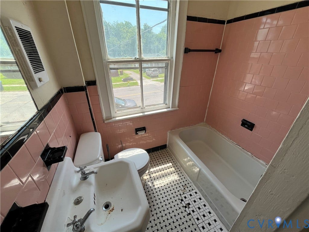 927 Farmer Street, Petersburg, VA 23803 Bathroom featuring a ceramic tile floor, pink wall tile, and a built-in bathtub