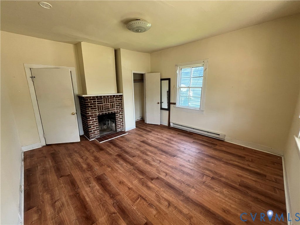 927 Farmer Street, Petersburg, VA 23803 Wood-finish flooring throughout, featuring a brick-surround fireplace