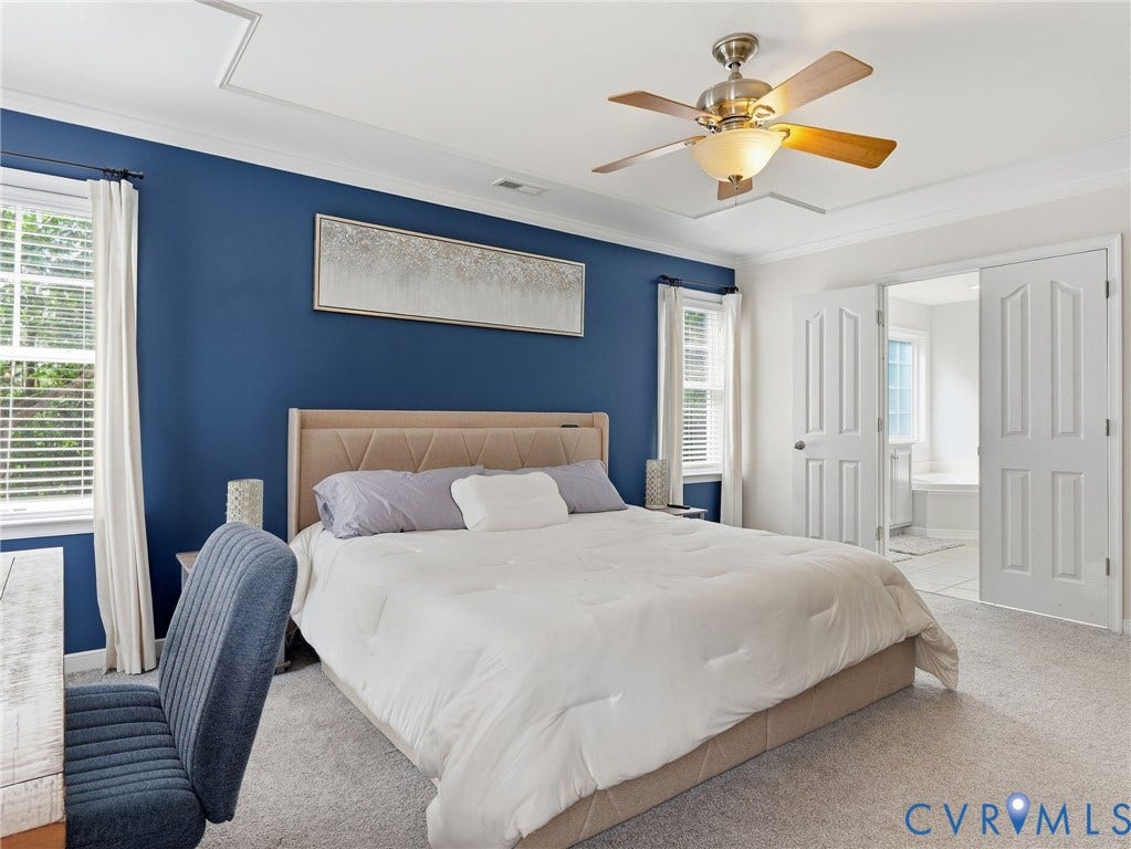 13925 Gorham Lane, Charter Colony, Midlothian, VA 23114 Tray ceiling with crown molding, ceiling fan with light fixture, carpeted flooring, double panel doors, and two windows with blinds