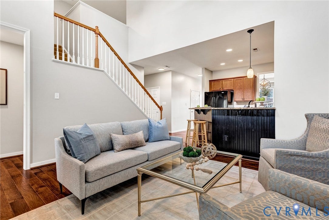 7728 Marshall Arch Drive, Liberty Trace, Mechanicsville, VA 23111 Hardwood flooring, two-story ceiling, kitchen pass-through with breakfast bar, wood cabinetry, and a staircase with wood handrail and white spindles