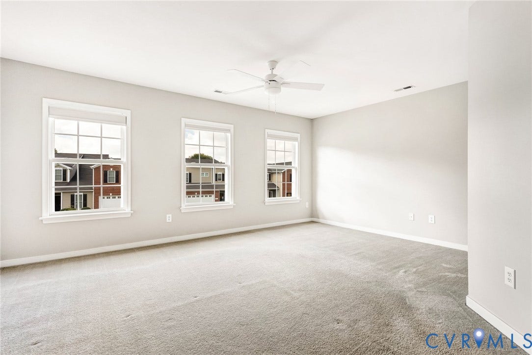 7728 Marshall Arch Drive, Liberty Trace, Mechanicsville, VA 23111 Bright room with three double-hung windows, light-toned carpeting, and a ceiling fan
