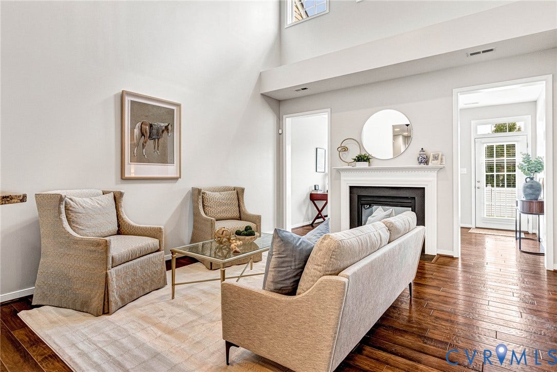 7728 Marshall Arch Drive, Liberty Trace, Mechanicsville, VA 23111 Vaulted ceilings and wood-finish flooring complement the fireplace with a white mantel and hearth