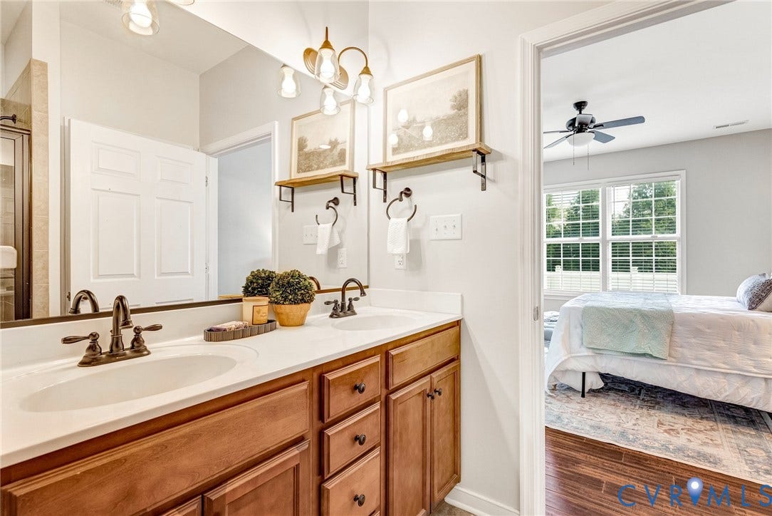 7728 Marshall Arch Drive, Liberty Trace, Mechanicsville, VA 23111 Dual vanity with bronze-finish fixtures and light wood-finish cabinetry