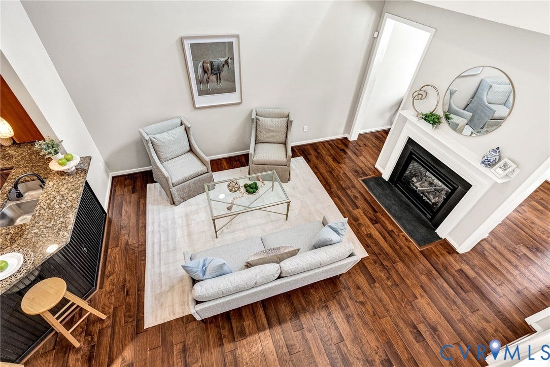 7728 Marshall Arch Drive, Liberty Trace, Mechanicsville, VA 23111 Vaulted ceiling enhancing vertical space, wood-finish flooring throughout, built-in fireplace with a white mantel, kitchen counter with an integrated sink, and an elevated counter