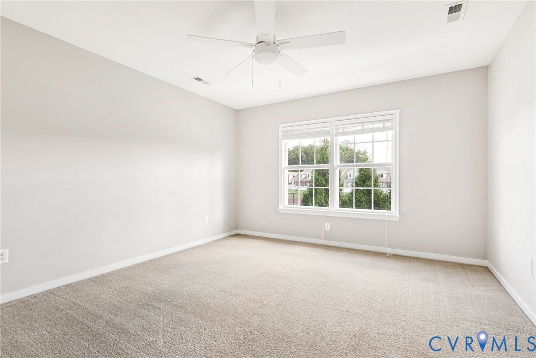7728 Marshall Arch Drive, Liberty Trace, Mechanicsville, VA 23111 Room with light neutral wall paint, white ceiling fan, and carpeted flooring
