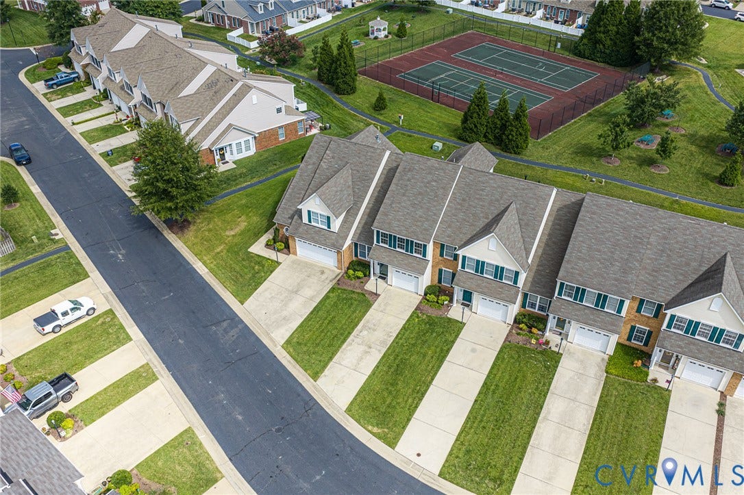7728 Marshall Arch Drive, Liberty Trace, Mechanicsville, VA 23111 Townhomes featuring brick and siding exteriors, attached garages, and individual driveways