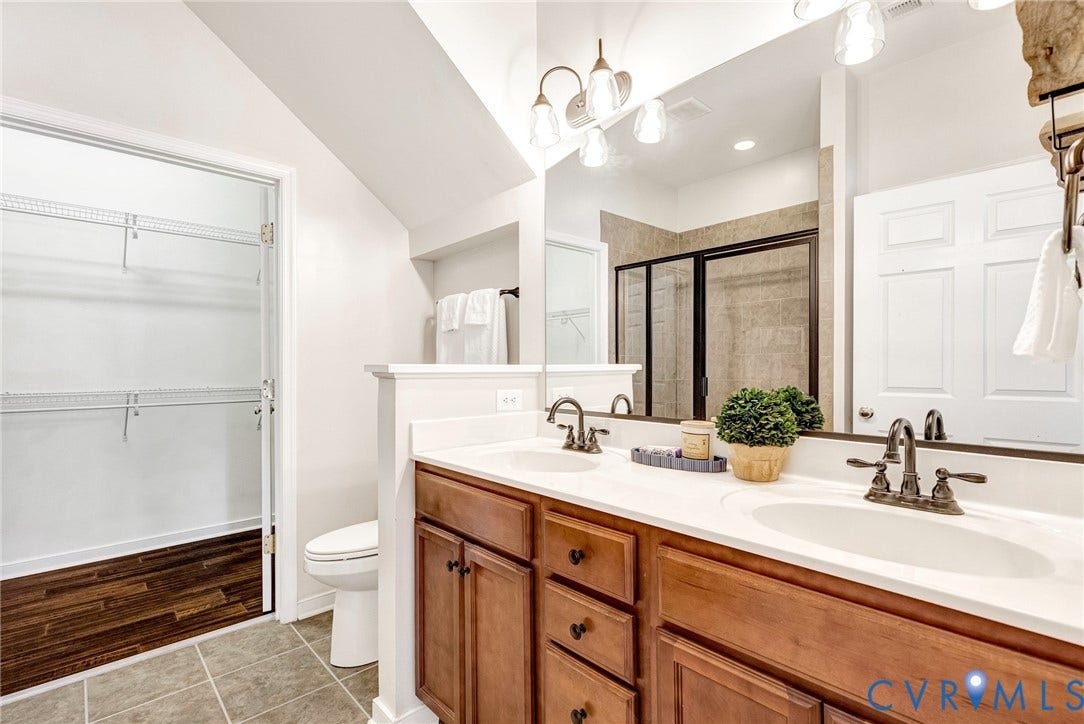 7728 Marshall Arch Drive, Liberty Trace, Mechanicsville, VA 23111 Dual sink vanity with wood-finish cabinetry and white countertop