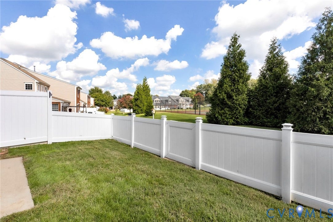 7728 Marshall Arch Drive, Liberty Trace, Mechanicsville, VA 23111 Expansive green lawn with a white privacy fence