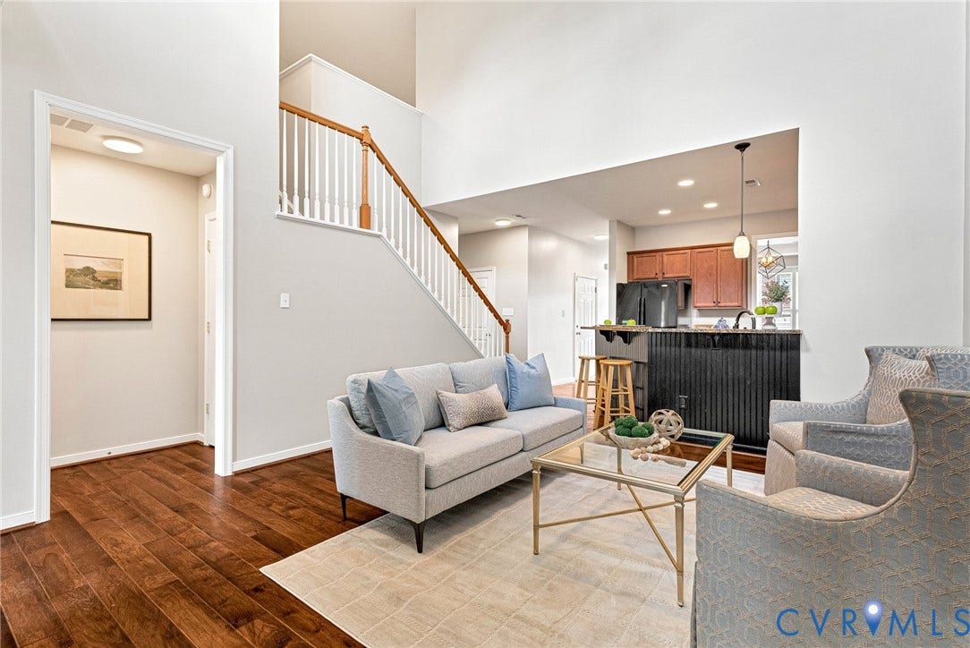 7728 Marshall Arch Drive, Liberty Trace, Mechanicsville, VA 23111 Expansive vaulted ceiling with a two-story staircase featuring wood handrails and white balusters