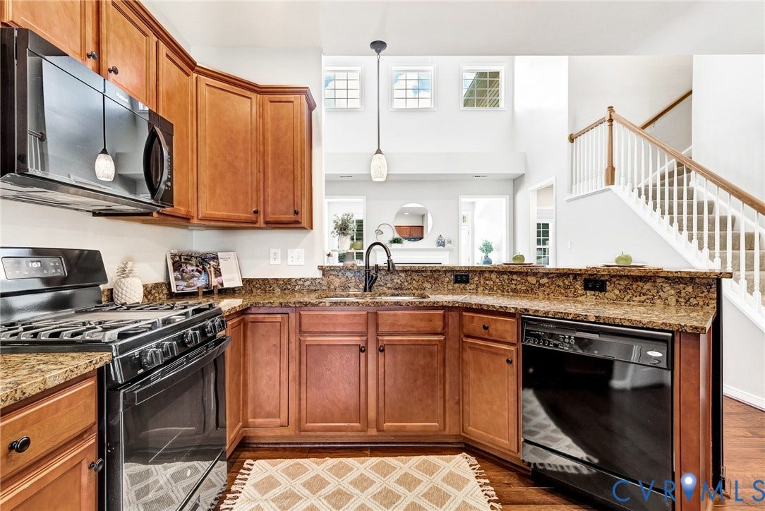 7728 Marshall Arch Drive, Liberty Trace, Mechanicsville, VA 23111 Kitchen featuring wood cabinetry, stone countertops, black appliances, and pendant lighting