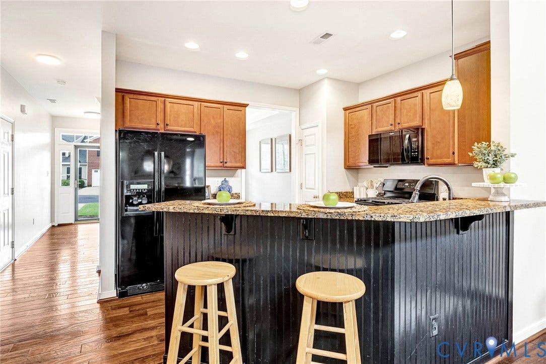 7728 Marshall Arch Drive, Liberty Trace, Mechanicsville, VA 23111 Kitchen featuring wood-finish flooring, granite-style countertops, wood cabinetry, built-in microwave, and black appliances