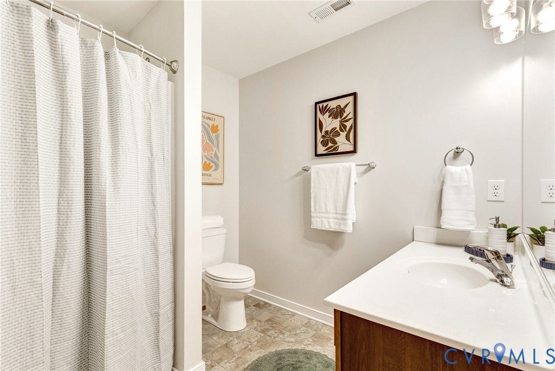 7728 Marshall Arch Drive, Liberty Trace, Mechanicsville, VA 23111 Bathroom featuring a vanity with a white countertop, undermount sink, and wood-finish cabinetry