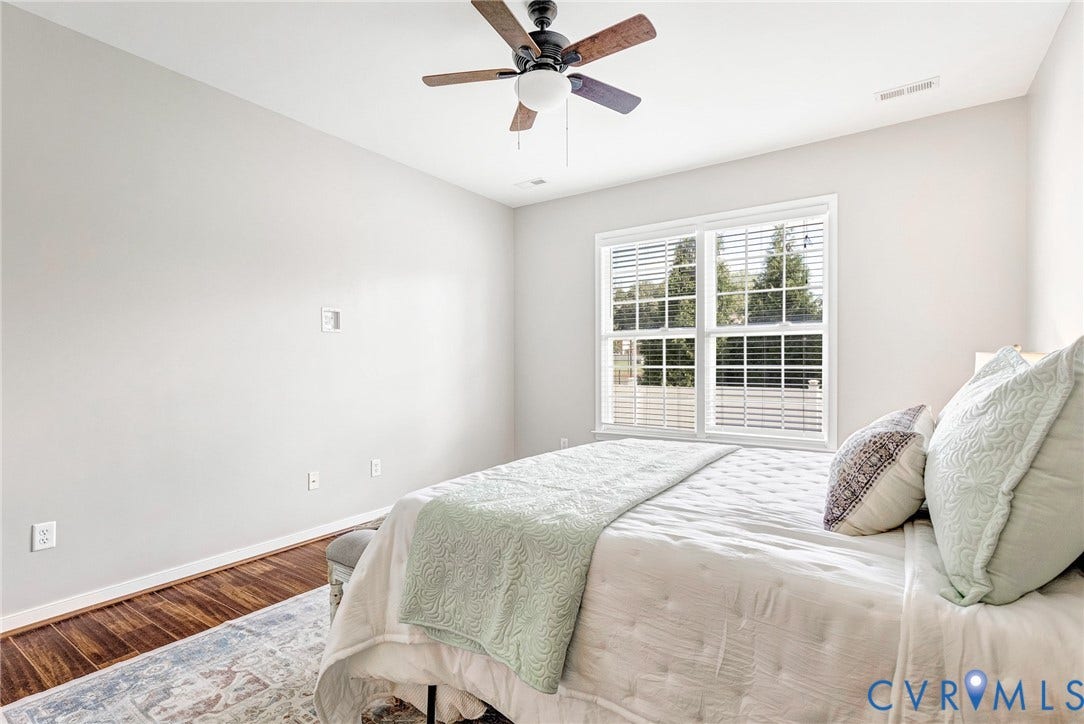 7728 Marshall Arch Drive, Liberty Trace, Mechanicsville, VA 23111 Wood-finish flooring with light-toned walls, a ceiling fan with light fixture, and a double window with blinds
