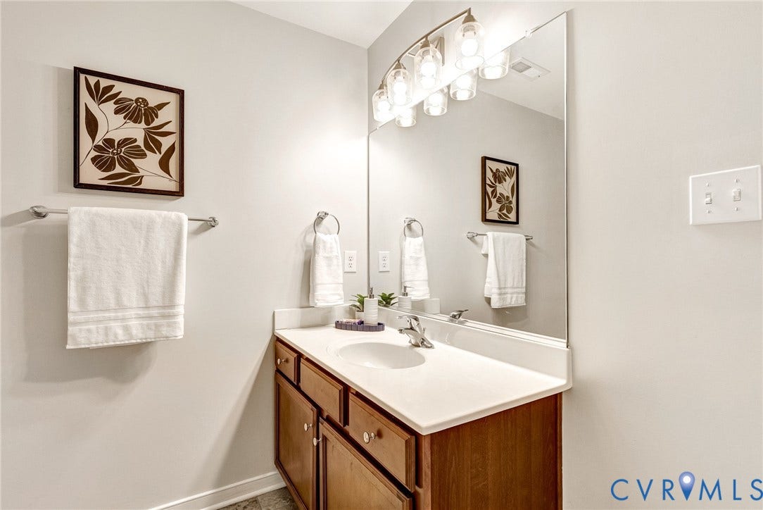7728 Marshall Arch Drive, Liberty Trace, Mechanicsville, VA 23111 Single vanity with a light-toned countertop, integrated sink, and wood-finish cabinetry