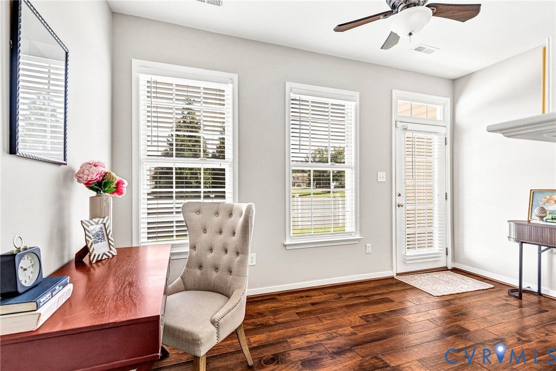 7728 Marshall Arch Drive, Liberty Trace, Mechanicsville, VA 23111 Wood-finish flooring throughout, two windows with blinds, and a white door with transom window