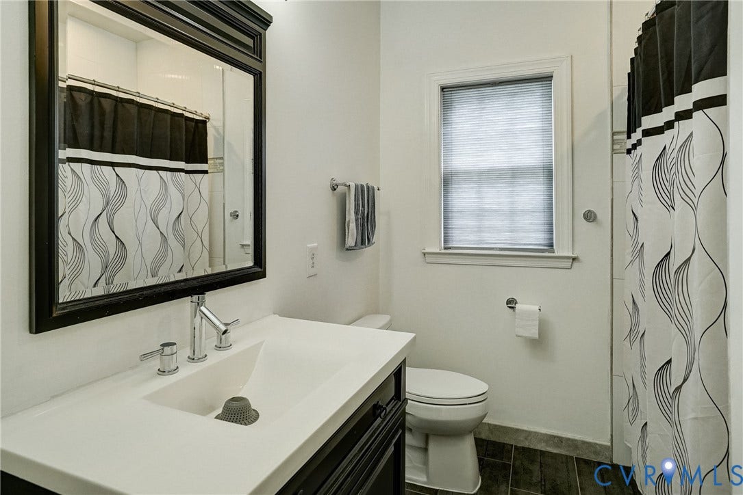 8805 Eli Place, Kings Forest, Glen Allen, VA 23060 Bathroom featuring a vanity with an integrated sink, polished chrome faucet, framed mirror, and a window with blinds