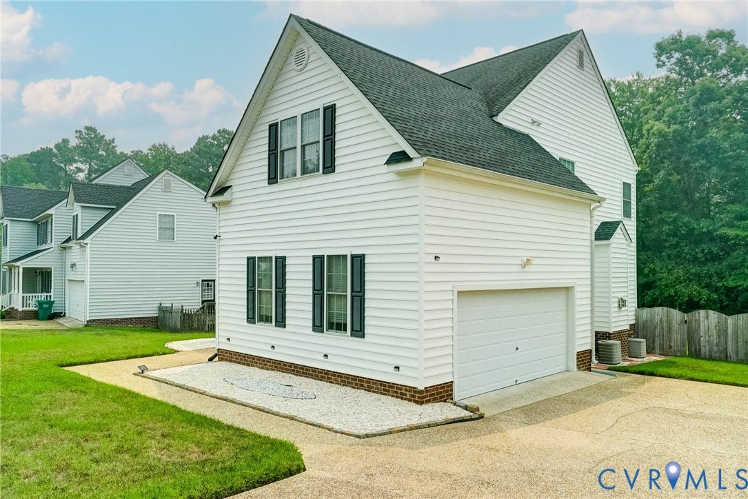 8805 Eli Place, Kings Forest, Glen Allen, VA 23060 White siding exterior with dark shutters, attached garage, and a gravel accent bed