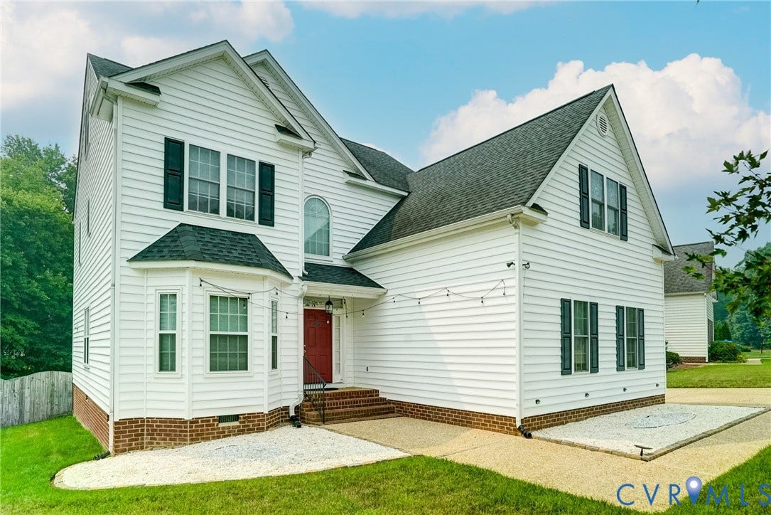 8805 Eli Place, Kings Forest, Glen Allen, VA 23060 White siding exterior with a red entry door, dark shutters, and a bay window