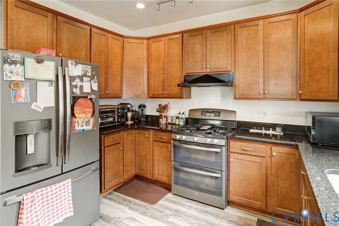 8805 Eli Place, Kings Forest, Glen Allen, VA 23060 Wood-finish flooring, dark stone countertops, stainless steel appliances, wood cabinetry, and recessed lighting