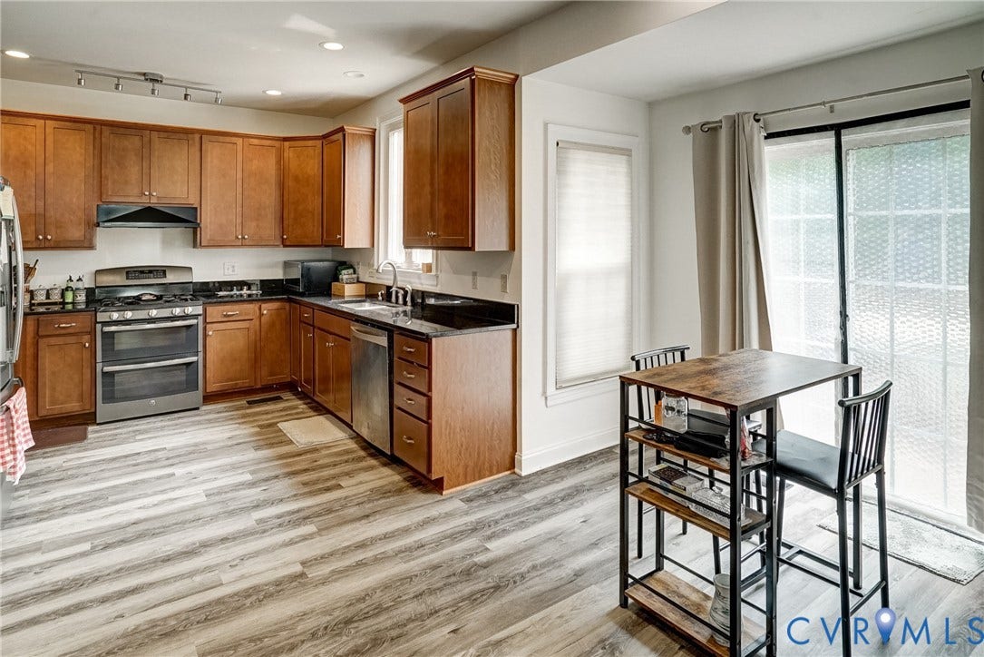 8805 Eli Place, Kings Forest, Glen Allen, VA 23060 Kitchen featuring wood-finish flooring, wood cabinetry, dark countertops, and stainless steel appliances