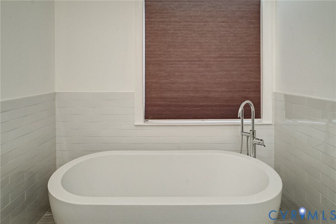 8805 Eli Place, Kings Forest, Glen Allen, VA 23060 Freestanding soaking tub with a floor-mounted polished chrome faucet, surrounded by tiled walls