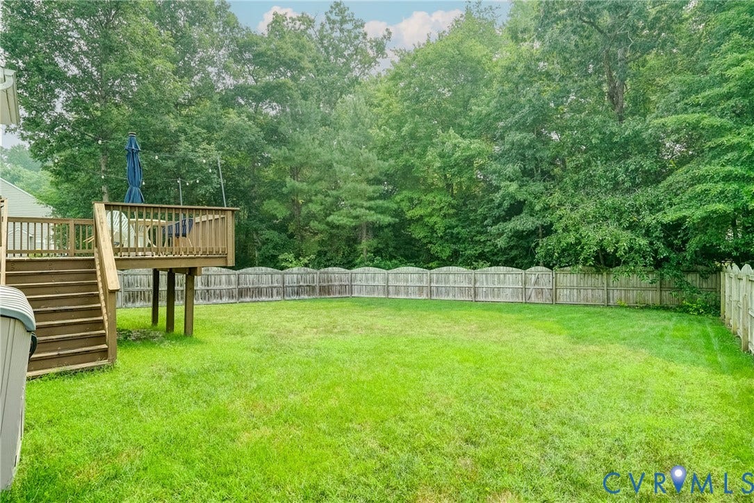 8805 Eli Place, Kings Forest, Glen Allen, VA 23060 Spacious grass lawn with a wood privacy fence and a raised wood deck with staircase access