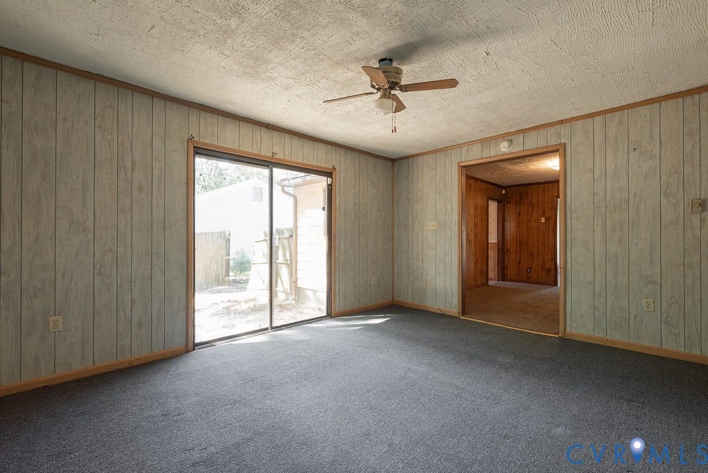 324 Lakewood Drive, Lakewood North, Petersburg, VA 23805 Sliding glass door to exterior, ceiling fan, carpet flooring, wood-paneled walls