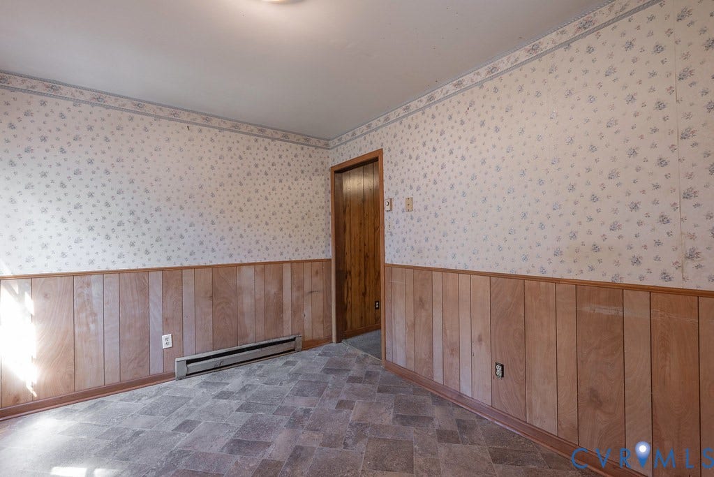 324 Lakewood Drive, Lakewood North, Petersburg, VA 23805 Neutral patterned wallpaper, wood paneling, wood trim, tile flooring, and a flush mount light fixture