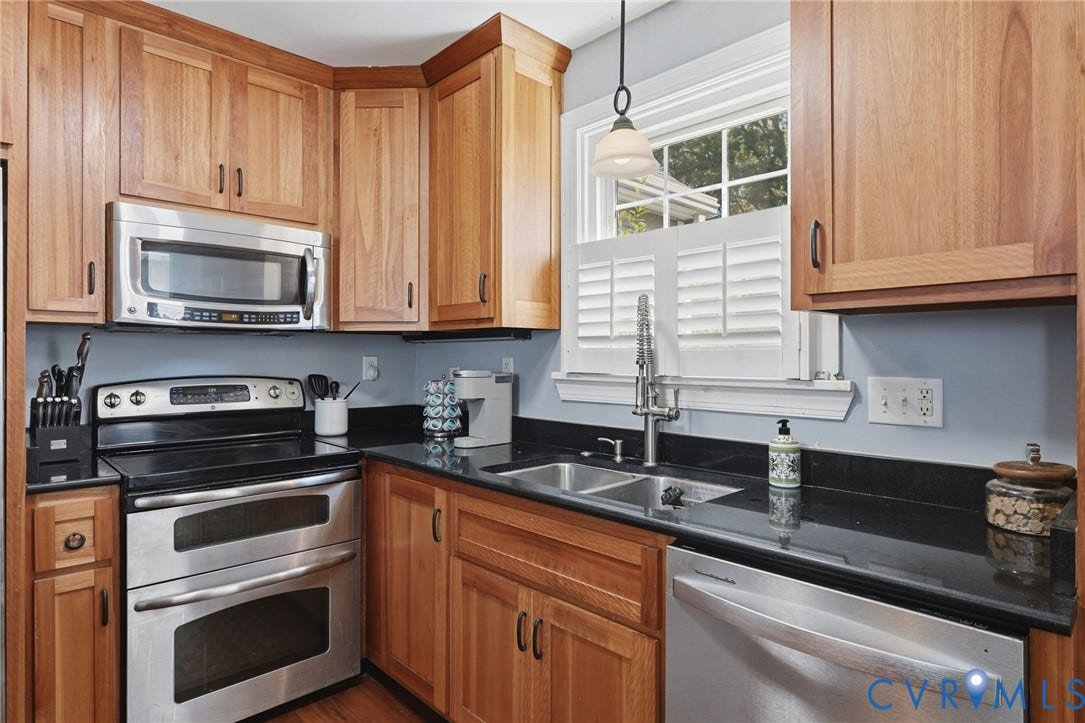 Wood-finish cabinetry paired with dark countertops