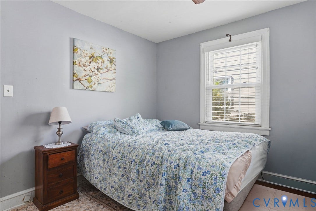 Single-hung window with white blinds and trim