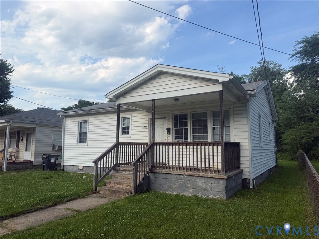 1227 Montgomery Avenue, Birdville Park, Petersburg, VA 23803 Front porch with wood railing and steps, white vinyl siding, and a dark shingle roof