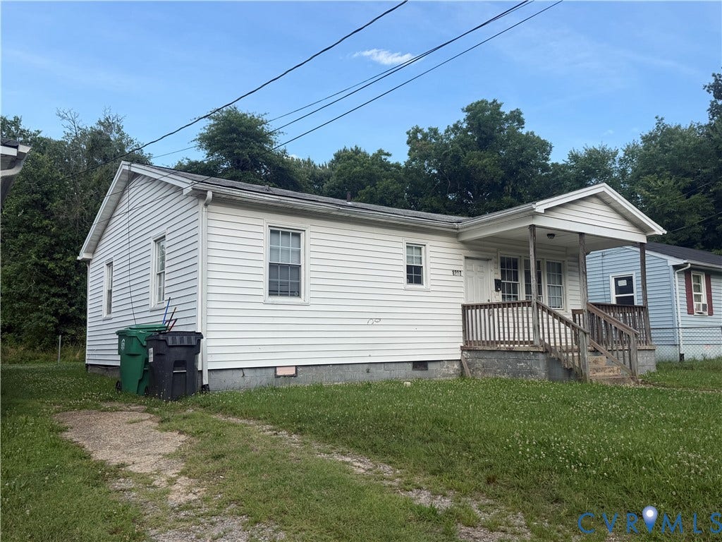 1227 Montgomery Avenue, Birdville Park, Petersburg, VA 23803 White siding exterior with a covered front porch featuring a wood railing
