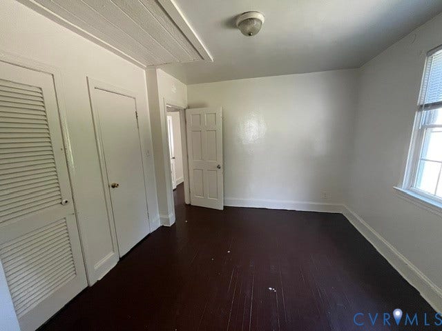1227 Montgomery Avenue, Birdville Park, Petersburg, VA 23803 Dark wood-finish flooring, white walls, and a recessed window