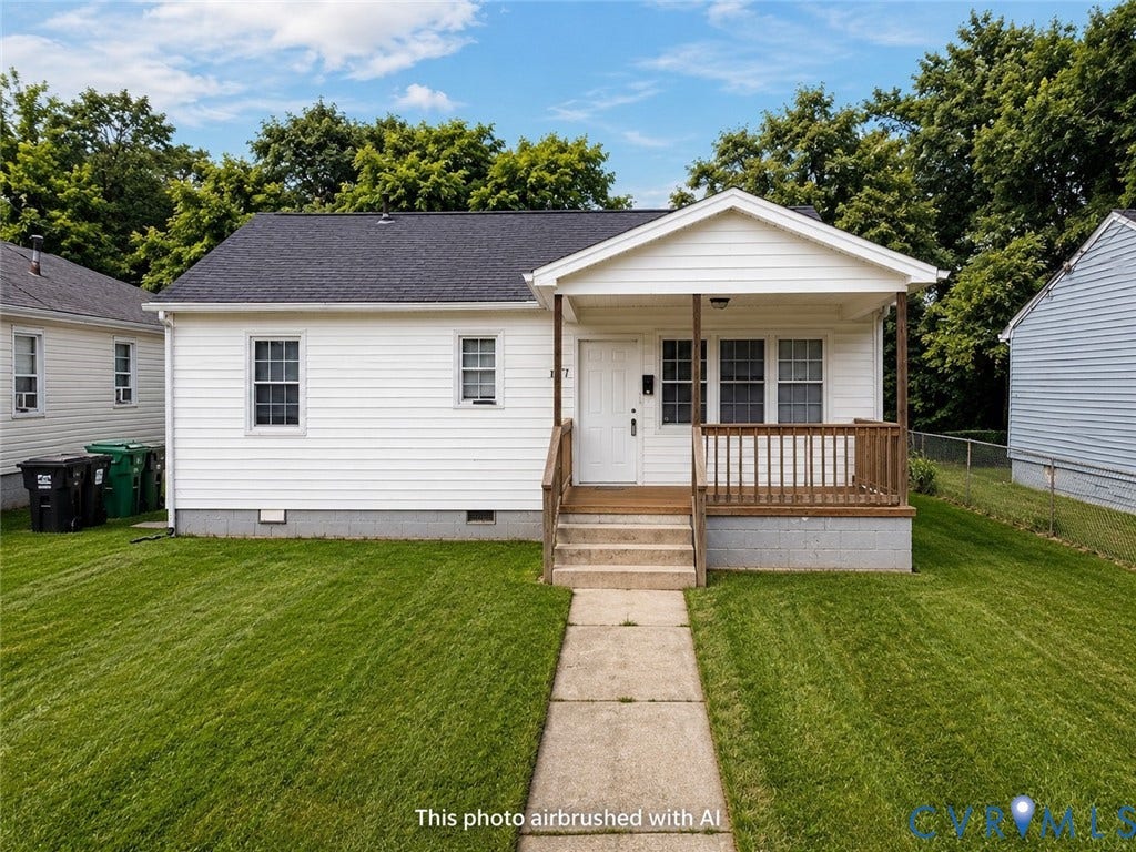 1227 Montgomery Avenue, Birdville Park, Petersburg, VA 23803 White siding exterior with a covered porch and wood-toned railings