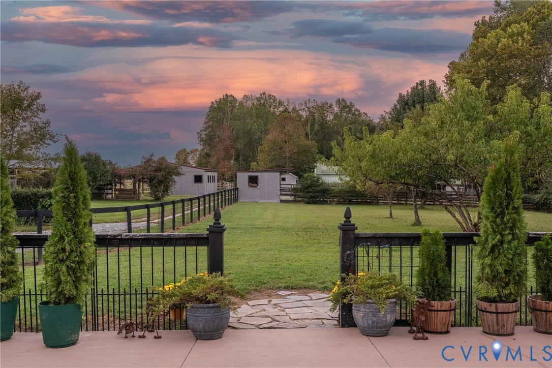 Fenced yard for dogs off of the patio.