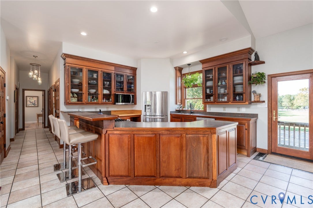 The eat-in kitchen with table space offers abundant cabinetry, island, workspace and an easy connection to the main living areas.