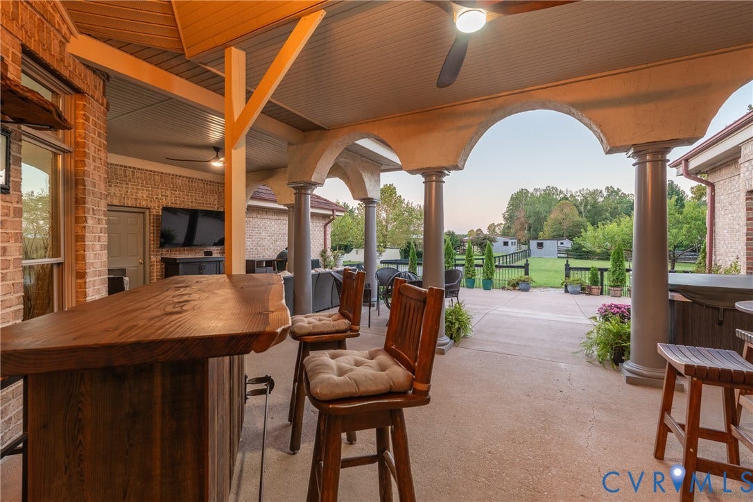 Generous covered entertaining space includes dedicated areas for dining and gathering.